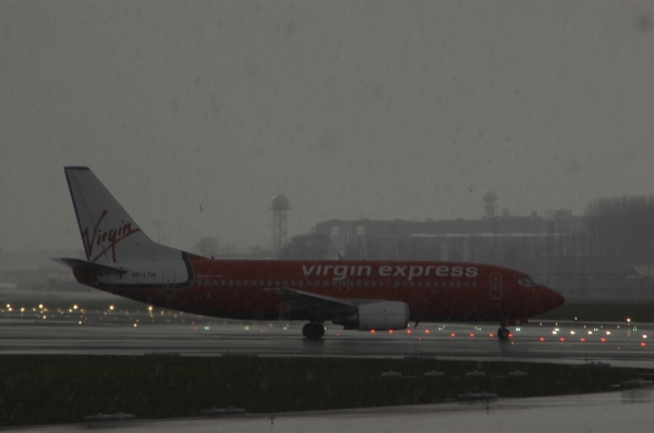 Virgin Express B737
Taxiing to runway 25R for Takeoff in snowy conditions.
